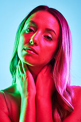 Image showing Woman skincare, portrait or neon lighting on isolated blue background for trendy studio fashion or cool style. Beauty model, face or creative aesthetic art and green, pink lights or makeup cosmetics