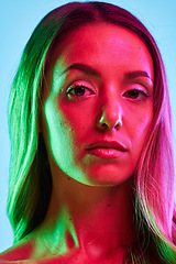 Image showing Portrait, skincare or glowing neon lighting on isolated blue background or studio fashion spotlight. Zoom, beauty model or woman face in creative fantasy green, pink or lights art aesthetic in makeup