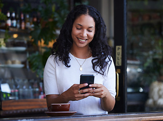 Image showing Woman in cafe, smile and smartphone for typing, social media and connection with online banking, relax and break. Female, customer and lady with cellphone, communication and in coffee shop for lunch