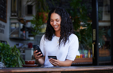 Image showing Woman, phone and credit card with smile for ecommerce, online shopping or purchase at coffee shop. Happy female shopper on smartphone for internet banking, app or wireless transaction at indoor cafe