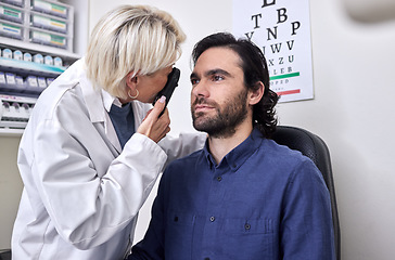 Image showing Doctor with a man in a vision test or eye exam for eyesight by doctor, optometrist or ophthalmologist with medical aid. Patient or client with a helpful senior optician to see or check glaucoma