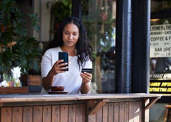 Image showing Woman, phone and credit card at cafe for ecommerce, online shopping or purchase. Happy female customer on smartphone for internet banking, app or wireless transaction at coffee shop or restaurant