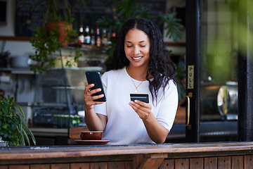 Image showing Woman, phone and credit card with smile for ecommerce, online shopping or purchase at coffee shop. Happy female customer on smartphone for internet banking, app or wireless transaction at cafe