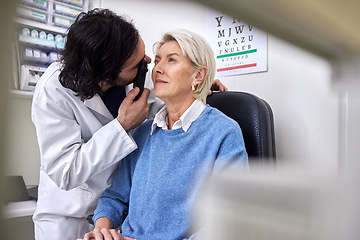 Image showing Senior patient in a vision test or eye exam for eyesight by doctor, optometrist or ophthalmologist with medical aid. Mature woman or client with a helpful optician to see retina or check glaucoma