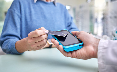 Image showing Finance, hands or payment with a credit card by a customer shopping in a transaction at optometrist. Financial, zoom or people make a fintech electronic machine purchase or pos after eye care help