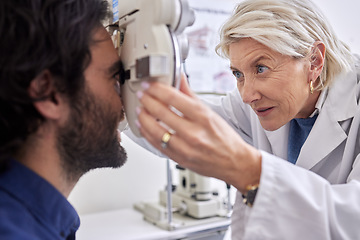 Image showing Doctor with a man in vision test or eye exam for eyesight by a focused senior optometrist or ophthalmologist. Optician helping check retina health of a client or happy customer with medical insurance