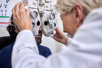 Image showing Doctor with customer in vision test or eye exam for eyesight by doctor, optometrist or ophthalmologist. Senior optician helping check retina health of a man, patient or client with medical insurance