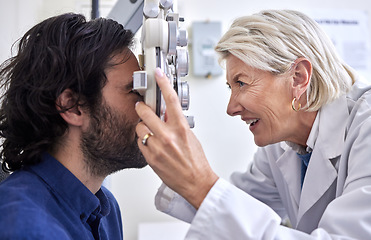 Image showing Doctor with a customer in vision test or eye exam for eyesight by a senior optometrist or ophthalmologist. Happy optician helping check retina health of patient, man or client with medical insurance