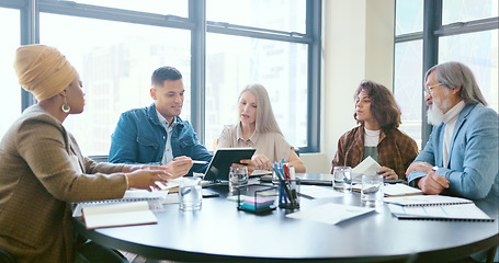 Image showing Business people, tablet and teamwork for planning, strategy and ideas by desk in modern office for goal. Corporate group, digital tech and finance team for brainstorming, vision or target in New York