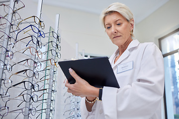 Image showing Glasses, optometrist and eye care with woman and tablet for retail, healthcare or consulting. Shopping, ophthalmology or technology with senior optician in frame store for medical, design or research