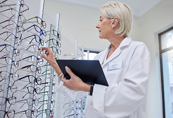 Image showing Glasses, optometrist and search with woman and tablet for retail, healthcare or consulting. Shopping, ophthalmology or technology with senior optician in frame store for medical, design or eye care