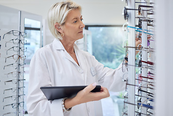 Image showing Glasses, optometrist and eye care with woman and tablet for retail, healthcare and Technology. Shopping, ophthalmology and search with senior optician in frame store for medical, design and internet