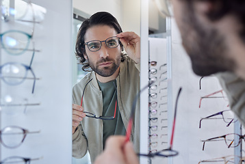 Image showing Glasses choice, optometry and man in mirror, vision check and eye care for customer experience of store lens frame. Young client or person eyes healthcare, retail and shop test for optical wellness