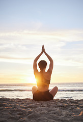 Image showing Woman, yoga and meditation on the beach for spiritual wellness or zen workout during sunset. Female yogi relaxing and meditating in sunrise for calm, peaceful mind or awareness by the ocean coast