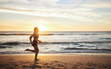 Image showing Woman, fitness and running on the beach sunset for healthy cardio exercise, training or workout in the outdoors. Female runner exercising in sunrise for run, health and wellness by the ocean coast