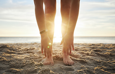 Image showing Stretching, fitness and feet of woman at beach for relax, wellness and yoga training. Sunset, health and peace with girl and warm up touching toes in sand for workout, energy and pilates exercise