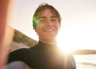 Image showing Selfie, surf and beach with a sports man outdoor in nature on the sand by the sea or ocean for recreation. Portrait, face or surfing with a male athlete posing for a photograph outside in the morning