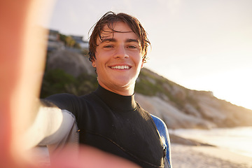 Image showing Selfie, surfing and beach with a sports man outdoor in nature on the sand by the sea or ocean for recreation. Portrait, face or surf with a male athlete posing for a photograph outside in the morning