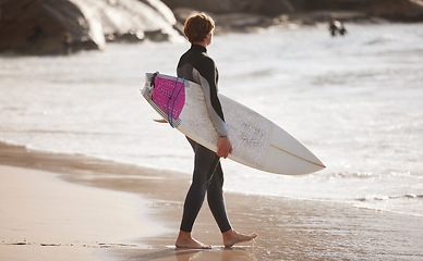 Image showing Surfing on beach, man with surfboard for sport outdoor, ocean and travel with mockup space and nature. Adventure, extreme sports and athlete walking, active lifestyle with surf on sea waves in Miami