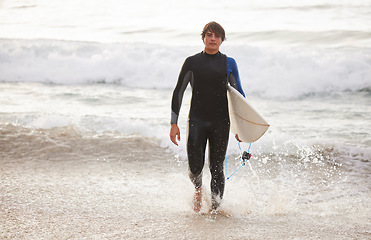 Image showing Summer, surfing and portrait of a man at the beach for water sports, relaxation and holiday in Bali. Sporty, training and surfer with a board for exercise, ocean break and activity on a vacation