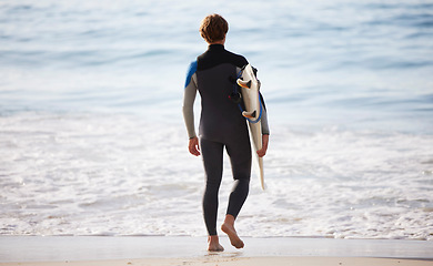 Image showing Surfer on beach, man with surfboard for sports outdoor, ocean and travel with mockup space and nature. Adventure, extreme sport and athlete walk, active lifestyle and surfing in Miami with back view