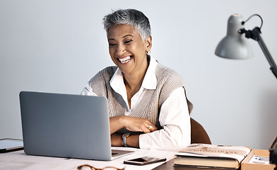 Image showing Senior business woman, laptop and office desk while happy about online communication or networking. Entrepreneur person with internet connection reading funny email, planning or website research