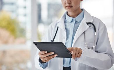 Image showing Digital tablet, healthcare and doctor doing research in the hospital for a diagnosis or test results. Technology, career and closeup of a female medical worker on a mobile device in a medicare clinic