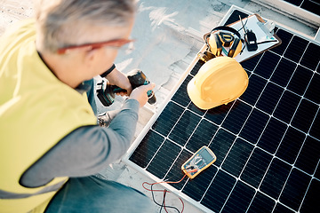 Image showing Solar energy, industrial work and senior construction worker on a building roof with panel. Sustainability, electricity and industrial grid with a mature engineer drilling with tools outdoor