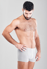 Image showing Fitness, body and underwear with a man model in studio on a gray background for health or grooming. Aesthetic, muscle and manly with a handsome young male posing to promote wellness or lifestyle
