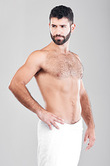 Image showing Body, man and skincare with towel, cosmetics and dermatology with hygiene, clean and guy on grey studio background. Male, thinking and hairy gentleman with idea, aesthetics and wellness on backdrop