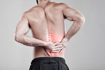 Image showing Man, hands and back pain in x ray for injury, bruise or spinal ache against a gray studio background. Male model suffering from broken spine, inflammation or muscle holding painful bone or area