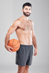 Image showing Sport, fitness and portrait of man with basketball and smile, topless and isolated on grey background. Exercise, motivation and ball sports coach or personal trainer with workout mindset in studio.