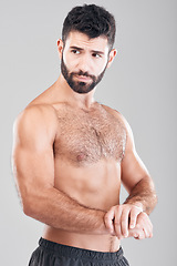 Image showing Fitness, body and man flexing his muscles in a studio after a workout or bodybuilding training. Sports, motivation and sexy muscular male model posing after exercise while isolated by gray background