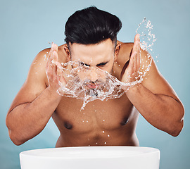 Image showing Man, water splash and face wash by basin for skincare, fresh clean hygiene or grooming against a studio background. Young male model in beauty, wellness and washing or cleansing for facial treatment