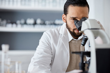 Image showing Science, microscope and analytics with a doctor man at work in a laboratory for innovation or development. Medical, research and biotechnology with a male scientist working in a lab for breakthrough