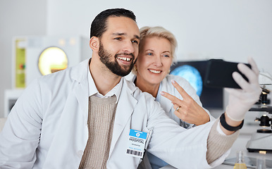 Image showing Science team, selfie and smile in lab for research, peace sign and happy at pharma company with phone. Scientist man, woman and profile picture for app, social network and teamwork with happiness