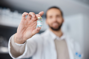 Image showing Vaccine, hand and healthcare with a doctor man holding a bottle of monkeypox treatment in a hospital. Medical, research and innovation with a container of vaccination treatment in a medicine clinic