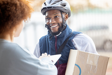 Image showing Black man, box and smile for delivery service, package or female customer order in city. Happy African American male courier employee smiling or delivering cargo to woman with clipboard for signature