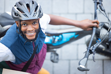 Image showing Black man, delivery bicycle and street portrait from top view for logistics, cargo and happy for job. Young african person, bike and shipping service with smile outdoor, helmet and safety in city