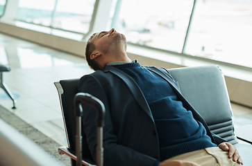 Image showing Airport, travel and tired businessman sleeping while waiting to board his plane for work in city. Exhausted, rest and professional corporate male employee taking nap while traveling with flight delay