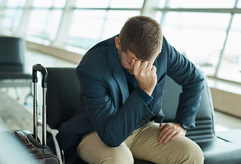 Image showing Airport, headache and stress man waiting to travel, frustrated and sad for transport delay, crisis or problem. Immigration, anxiety and person thinking, fail or mistake for international flight news