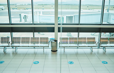 Image showing Empty airport, chair or furniture in departure lounge, covid compliance or coronavirus lockdown in global healthcare laws. Air travel, seats or waiting area and nobody in bacteria control management