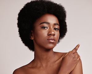 Image showing Portrait, beauty or skin and a model black woman in studio on a gray background with afro hair. Skincare, cosmetics and natural with an attractive young female posing indoor for health or wellness