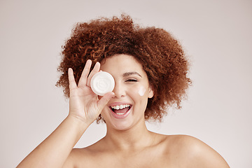 Image showing Skincare, beauty and portrait of happy woman with cream container, smile and afro, advertising luxury skin product promotion. Dermatology, cosmetics and facial for model isolated on studio background