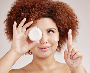 Image showing Skincare, woman with cream on finger and jar with smile, advertising luxury skin product promotion. Dermatology, cosmetic and facial beauty for happy model isolated on studio background and lotion.