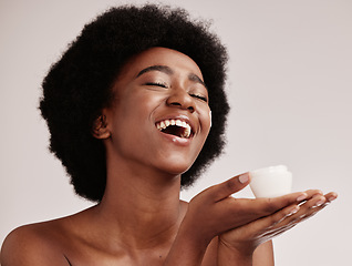 Image showing Skin care, beauty cream and a black woman in studio happy with dermatology cosmetic container. Aesthetic model with hands for product placement for health, wellness and face skin glow grey background