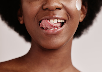 Image showing Beauty, face or tongue over teeth in dental care, mouth hygiene or oral wellness in healthcare grooming. Zoom, black woman or model licking lips in skincare product glow, clean orthodontics or makeup