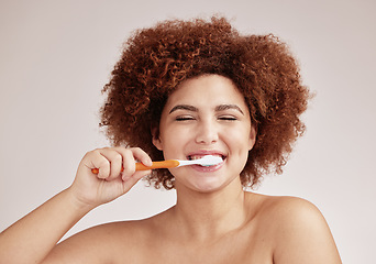 Image showing Happy woman, brushing teeth and toothbrush for clean and healthy mouth on studio background. Face of person advertising dentist tips for dental care, hygiene and cleaning with a mint breath smile