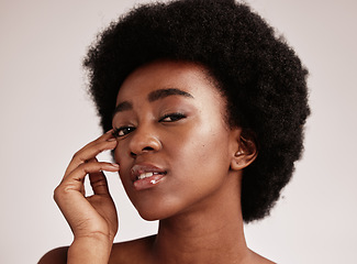 Image showing Portrait, beauty or natural and a model black woman in studio on a gray background with afro hair. Skin, cosmetics and skincare with an attractive young female posing indoor for health or wellness