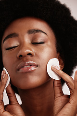 Image showing Cleaning face, skin care and cotton for black woman in studio with dermatology, cosmetics and detox. Aesthetic model with hands on natural facial skin to clean makeup, beauty and wellness for spa